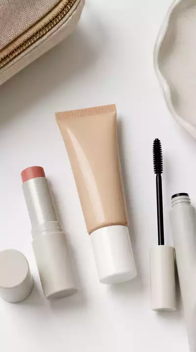 Woman organizing her minimalist beauty kit with skincare products