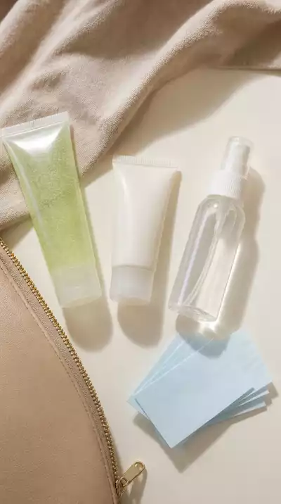 Assortment of travel-sized beauty products on a clean surface